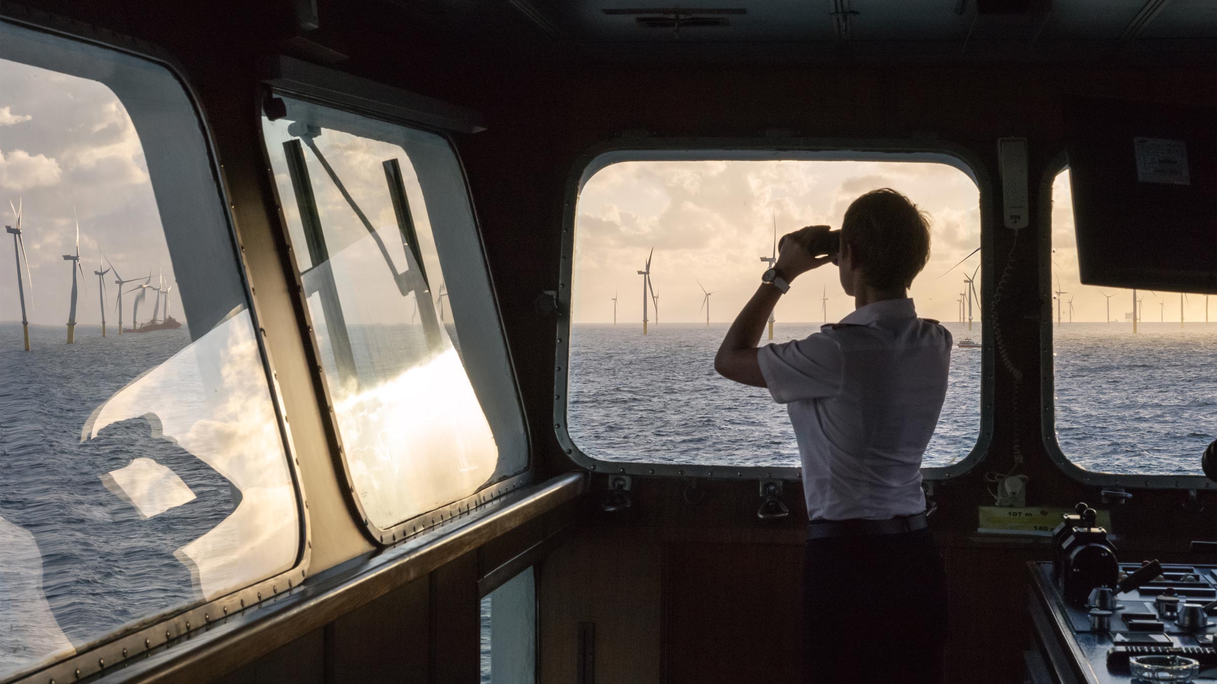 Luca Locatelli, Energiewende — Regina Baltica. Germany, 2015. Regina Baltica vice captain overlooking a wind farm in the North Sea, Germany. Regina Baltica serves as a floating hotel for offshore wind farm technicians. Courtesy of Luca Locatelli.